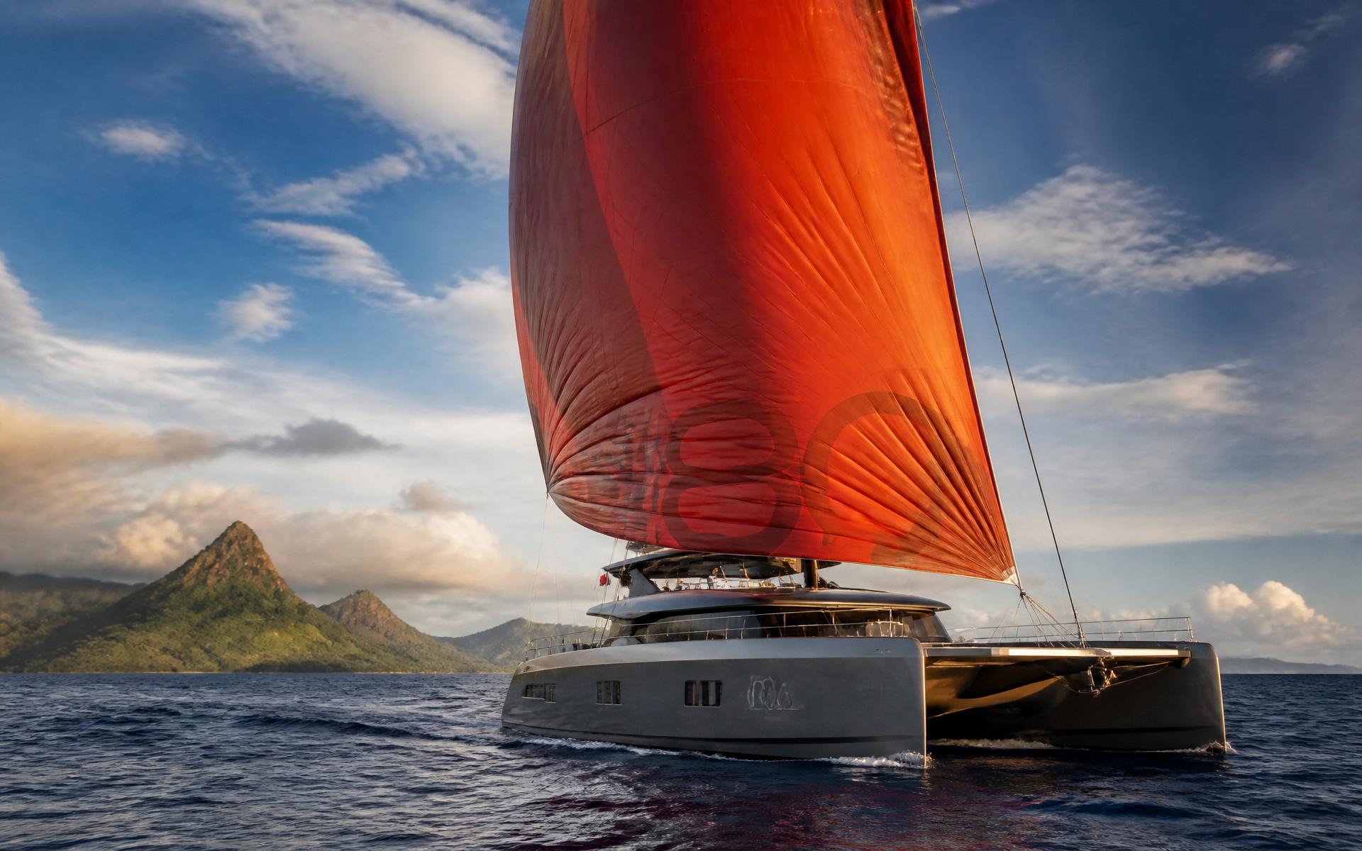 Sunreef 80 sailing catamaran crossing open ocean at golden hour